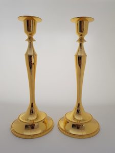 A SET OF TWO SINGLE GOLDEN CANDLE HOLDERS