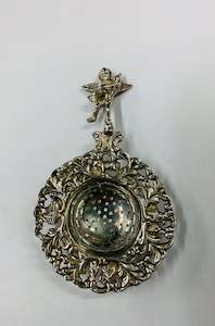 Ornate silver plated tea strainer