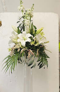 Florist: Flower Arrangement on top of a tall cylinder