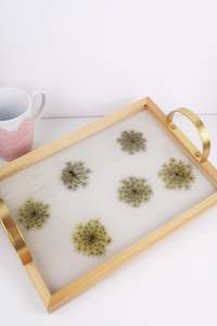 Wooden tray with gold handles.