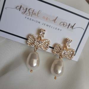 Hazel - Swarovski crystal pearl drop and cubic zirconia bow gold-tone stud earrings