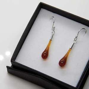 Wearing Glass Ear drops Amber