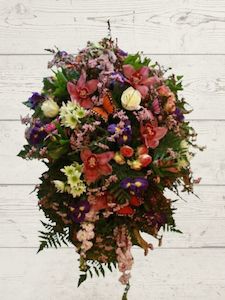 Florist: Pastel Floral tribute for Casket.