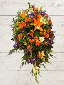 Florist: Bright Floral tribute for Casket.