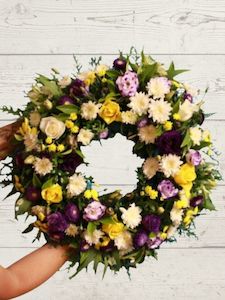 Florist: Bright Sympathy wreath.