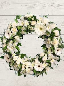 Florist: White sympathy Wreath.