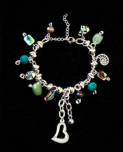 Graphic design service - for advertising: Kiwiana stainless steel charm bracelet Fossil Studios