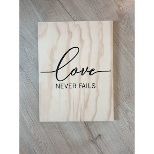 Love Never Fails Wooden Sign