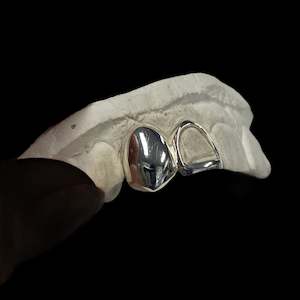 Two teeth in Sterling Silver, one fully capped one framed