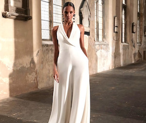 Products: Bonnie 11280 Madison Rose Bridal on trend chic jumpsuit with flattering v neckline and wide legged pants. Beautiful illusion lace panelled back complements the stunning simplicity