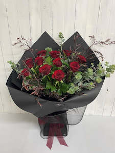 A dozen Red Roses stunningly wrapped in black