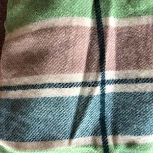 Building supplies: Brown, blue, cream and green stripe wool vest