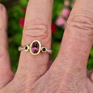 Jewellery: Chloris ring, oval pink tourmaline and ruby. 24ct gold and silver. Size N