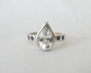 White topaz pear ring with blue sapphires in sterling silver