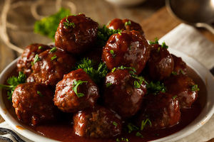 Products: Asian Meatballs with a Sweet Tamarind Sauce and Sautéed Greens with Roasted Ginger Carrots and Spring Onions and Toasted Sesame Seeds 