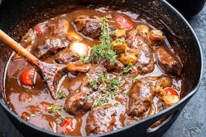 Mediterranean Braised Lamb with Roasted Root Vegetables and Seasonal Greens with Fresh Herbs