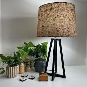 Furniture: Black tripod table lamp, eastern paisley