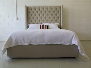 Winged deep buttoned upholstered bed