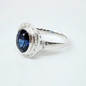 Sterling Silver 10mm x 13mm Ocal Cut Bezel Set Blue CZ and Halo CZ Setting Ladies Dress Ring