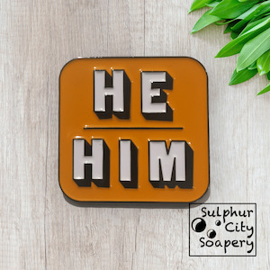 He / Him Pronoun Pin - in black and orange