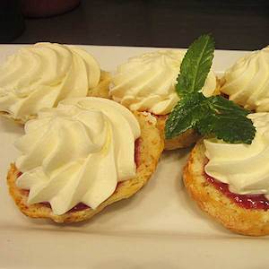 Sweet Scone Half topped with jam and whipped cream