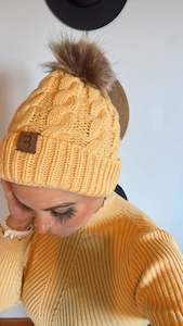 Yellow pom pom beanie