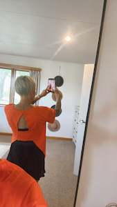 Womenswear: Orange cut out back round neck tee