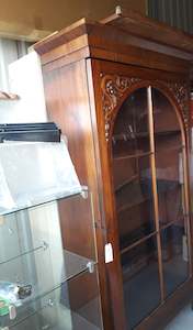 Mahogany bookcase/showcase with wooden astragals & intricate carvings on arch